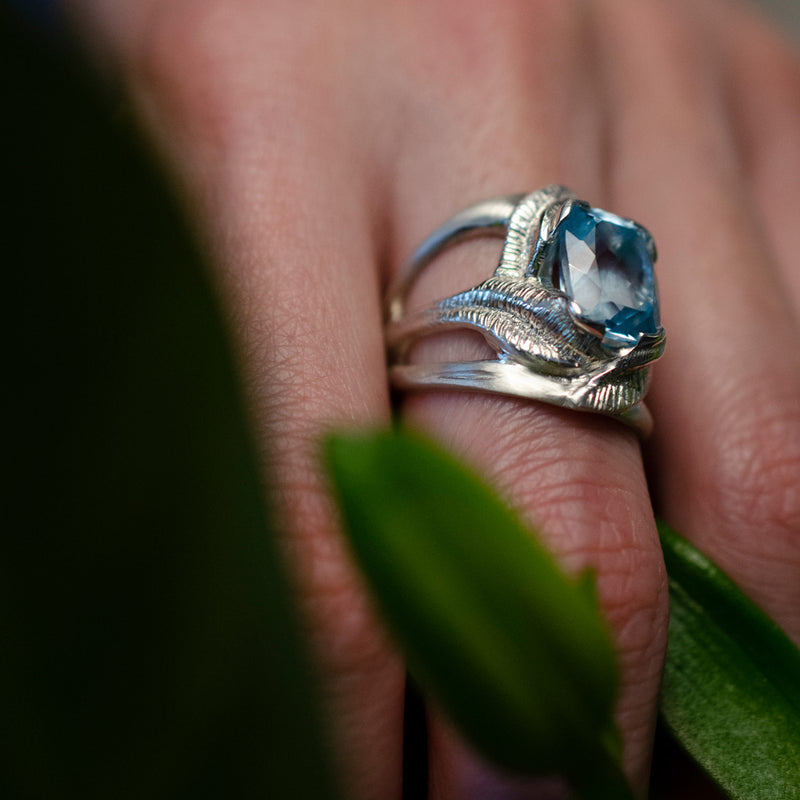 CAHYA Handcarved Botanical Cocktail Ring with faceted cushion-cut topaz gemstone on a model